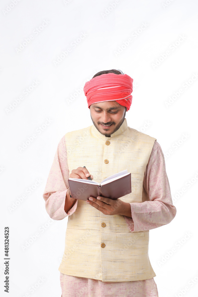 Indian farmer using diary on white background. Indian farmer using diary on white background.
