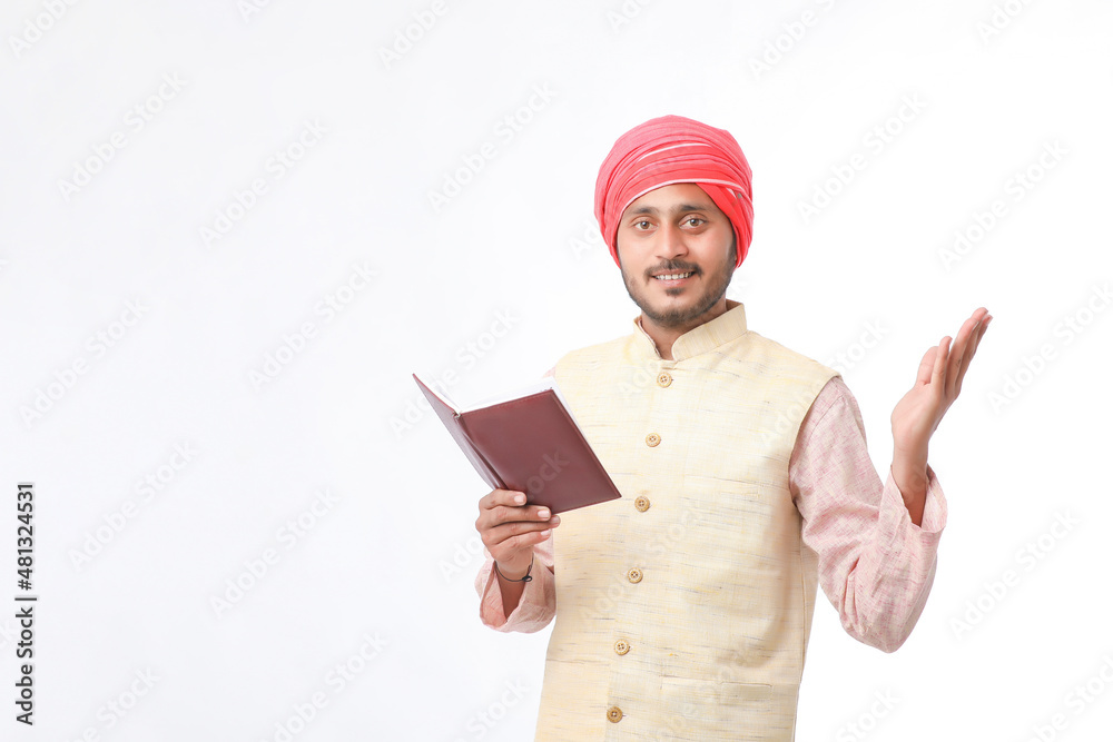 Indian farmer using diary on white background. Indian farmer using diary on white background.