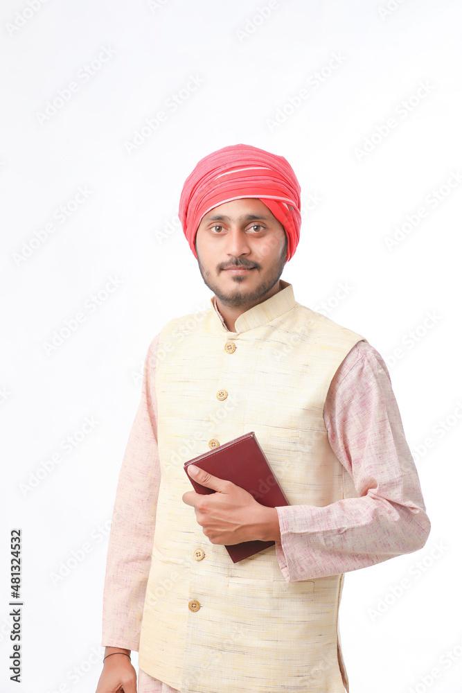 Indian farmer using diary on white background. Indian farmer using diary on white background.