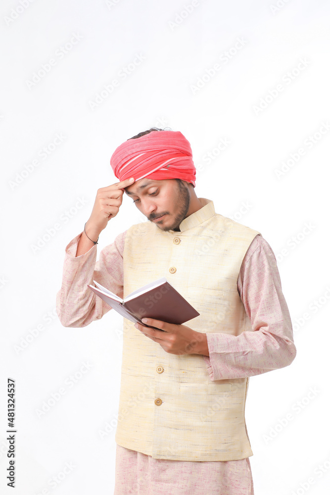 Indian farmer using diary on white background. Indian farmer using diary on white background.
