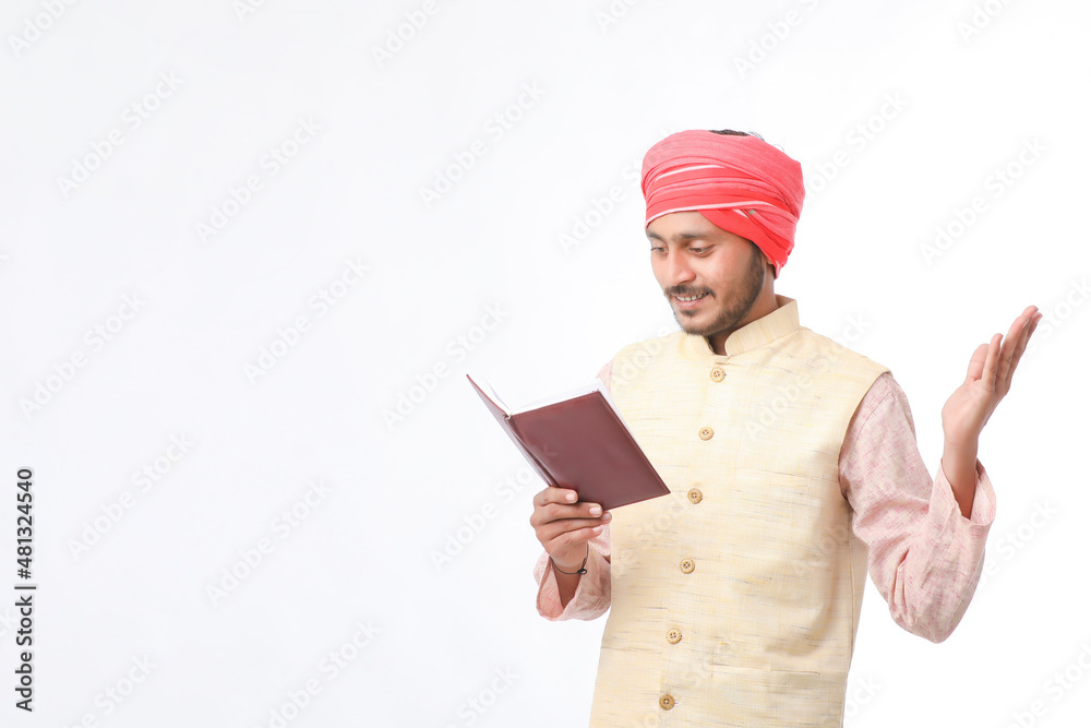 Indian farmer using diary on white background. Indian farmer using diary on white background.