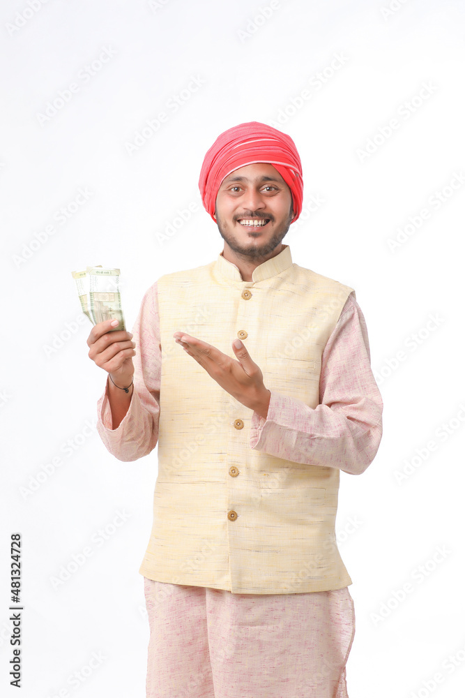Young indian farmer showing money on white background.