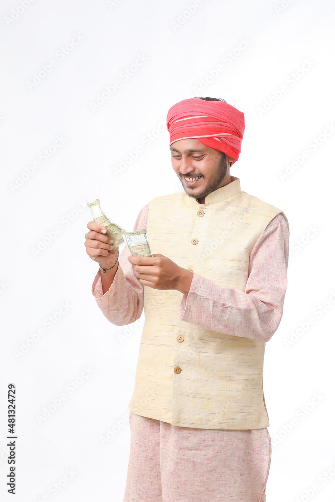 Young indian farmer showing money on white background. Young indian farmer showing money on white background.