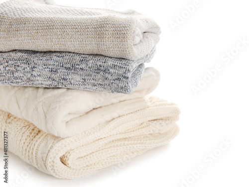 Stylish baby sweaters on white background