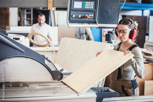 male and female carpenter at work, man and woman are crafting with wood in a workshop