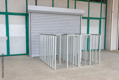 Football stadium entrance. Closed door and empty iron railings.