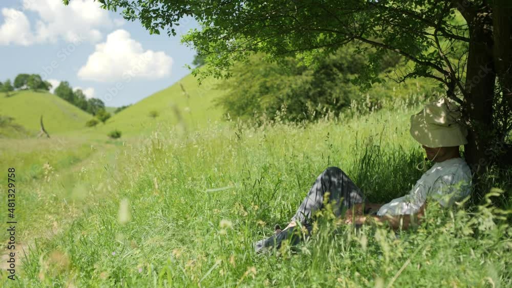 Man sleeping in the shadow of a tree