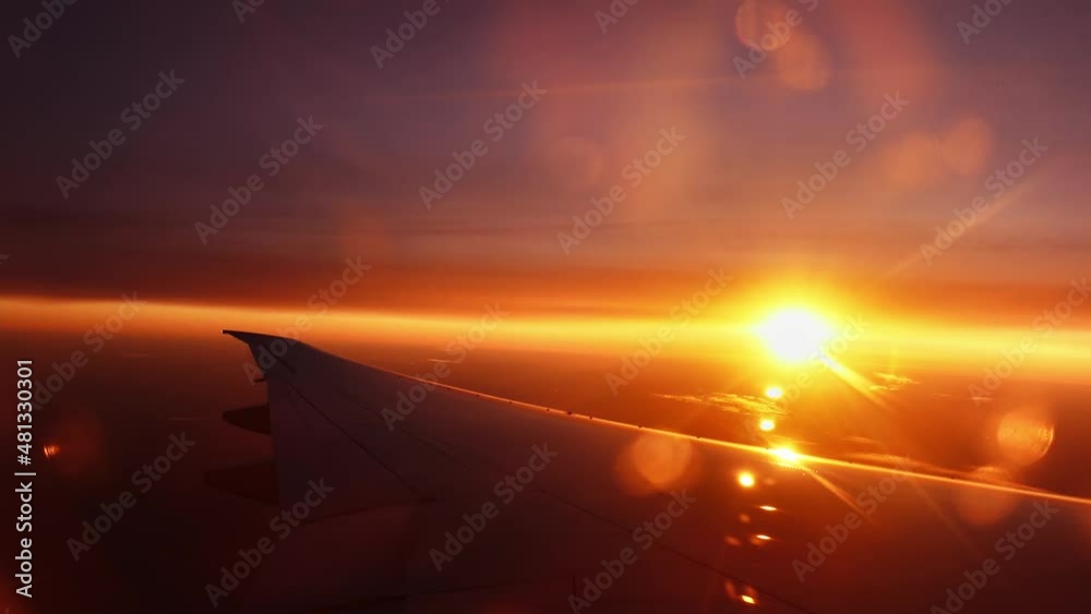 The sky flooded with sunlight and lens flare is filmed from the window ...