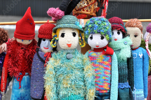 Colorful handmade knitted dolls. Close Up. Showcase at the fair