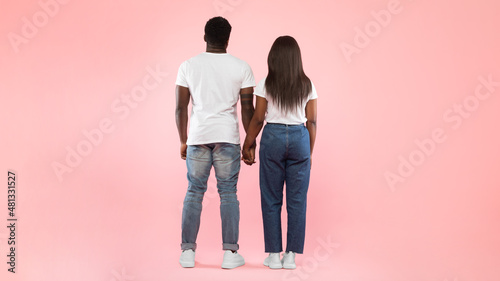 Photography Confident couple standing abck to camera at pink studio background