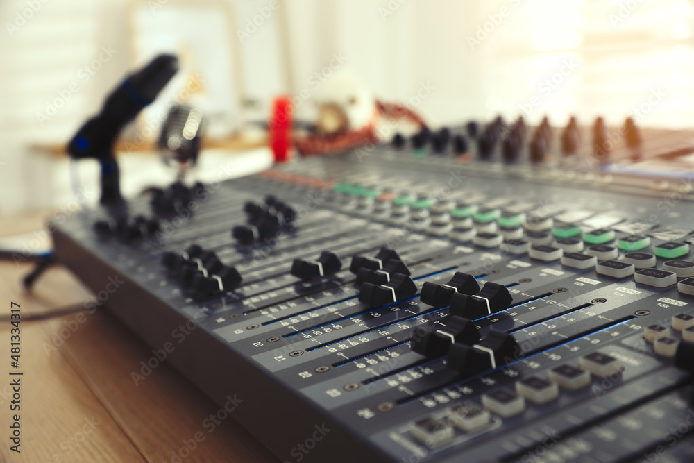 Professional mixing console on table in modern radio studio, closeup Professional mixing console on table in modern radio studio, closeup
