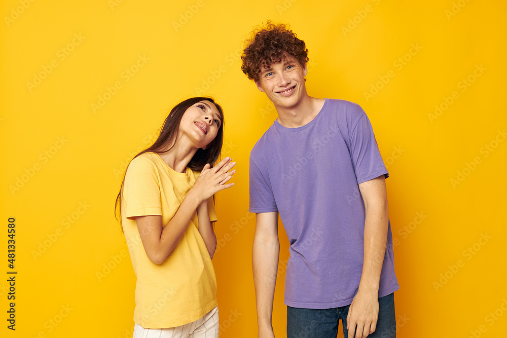 Fototapeta premium portrait of a man and a woman Friendship posing fun studio yellow background unaltered