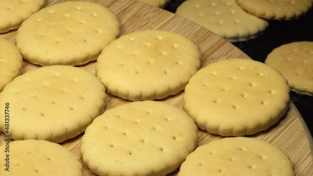 Oval crackers on a wooden plate. Rotation background. Close up Oval crackers on a wooden plate. Rotation background. Close up