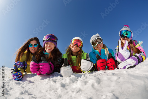 Group of friends snowboarders having fun on the top of mountain