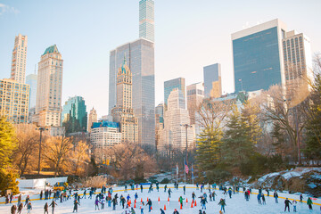 Ice skaters having fun in New York Central Park in winter