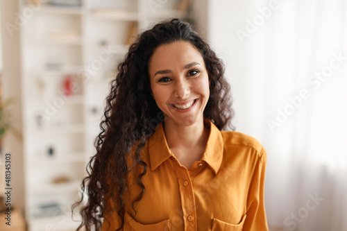 Fotografie, Obraz Happy Middle Eastern Businesswoman Wearing Shirt Smiling To Camera Indoors
