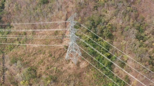 Transmission tower, power tower or electricity pylon. Consist of steel structure framing to support or carry cable, high-voltage powerline or overhead power line. For electrical grid in aerial view.
 photo