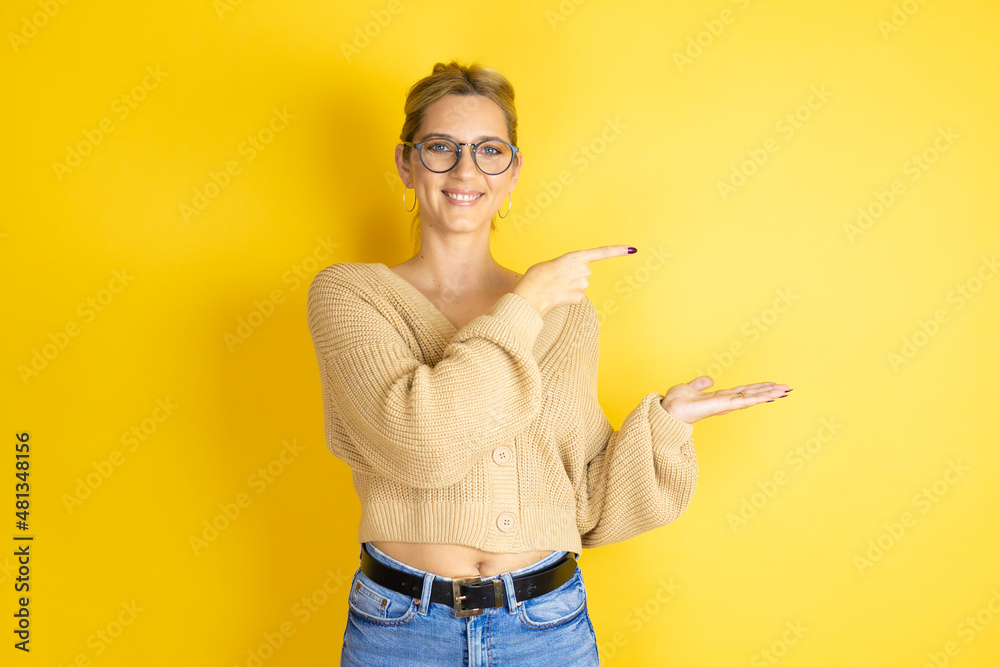 Φωτογραφία Young beautiful woman wearing casual sweater over isolated yellow background sur