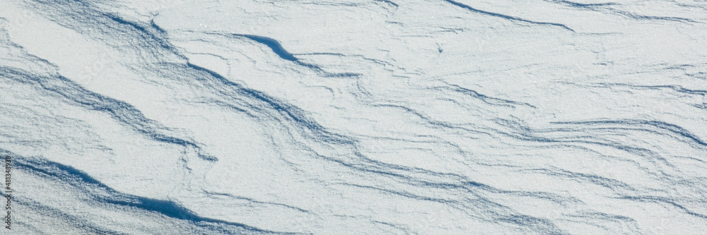 Snow texture with snow waves. Winter nature background.