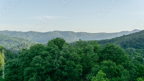 Picturesque mountain landscape with green forest peaks of Caucasus Mountains. Spring landscape at the pass in Goryachiy Klyuch. Krasnodar region, Russia photo