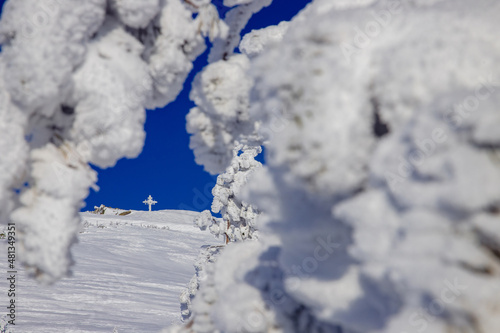 Winter Landscape of frozen worship cross mountain with blue sky Kemerovo region Russia
