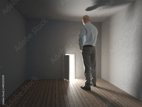a big man stands in front of a small door 
