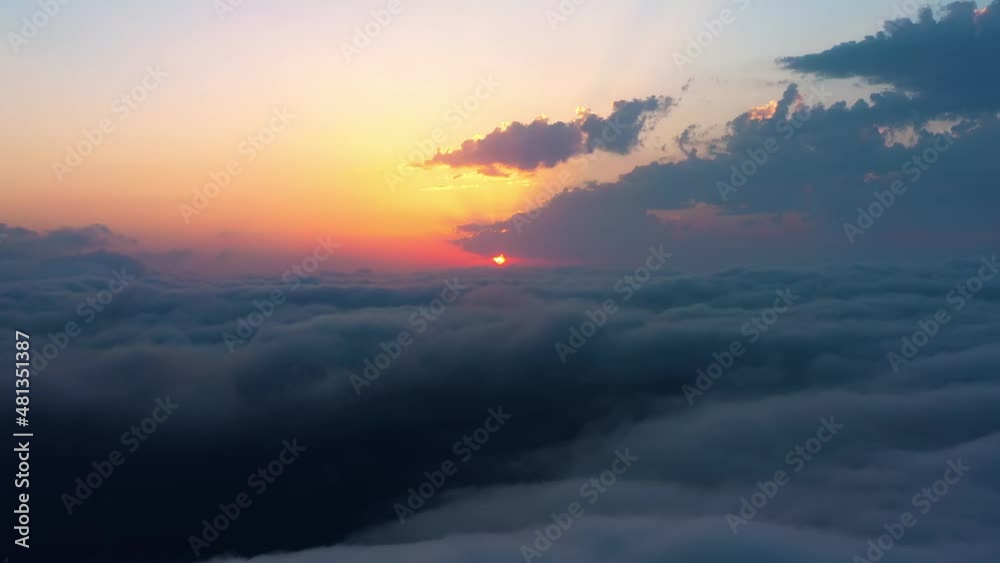 Flying over the clouds with the late sun. Sunrise or sunset colorful sky background. Flying over the clouds with the late sun. Sunrise or sunset colorful sky background.