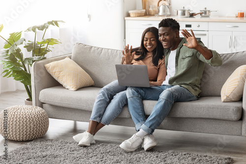 Happy african american family using computer at home