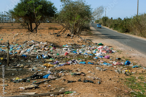 photo of scattered garbage by the road. The concept of waste disposal and environmental pollution photo
