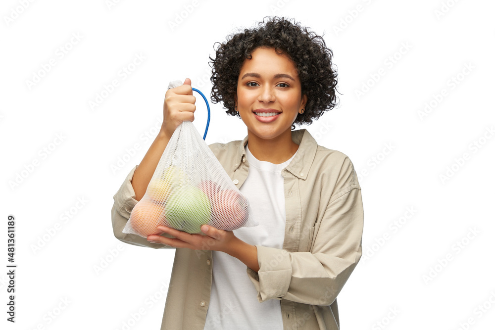 sustainability, eco living and people concept - portrait of happy smiling woman holding reusable string bag with fruits over white background sustainability, eco living and people concept - portrait of happy smiling woman holding reusable string bag with fruits over white background