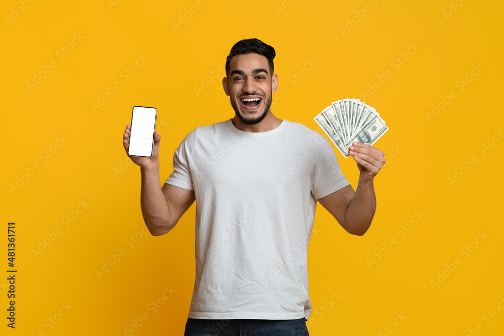 Emotional middle eastern guy showing smartphone and cash