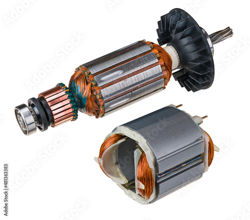 Electric DC motor stator and rotor with plastic fan isolated on a white background. Two engine parts with steel sheets, copper commutator or wire winding and metal ball bearing. Electronics industry.