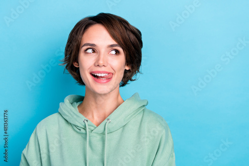 Photo of pretty millennial bob hairdo lady look promo wear green pullover isolated on blue color background photo