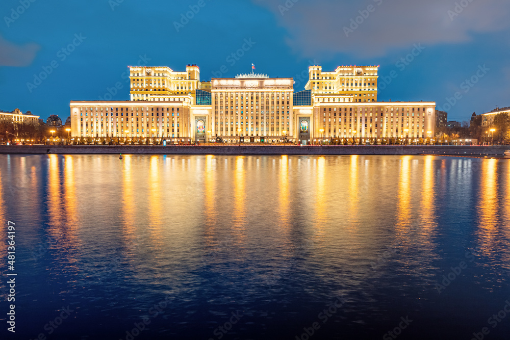 Ministry of Defense building in the evening with lights and reflection in the water of the Moskva River. Concept of the armed forces and political power in the Russian Federation