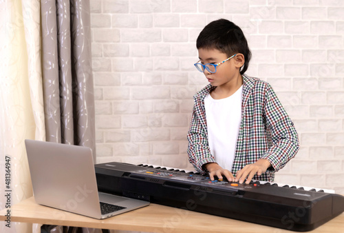 Happy boy learning to play musical instruments online