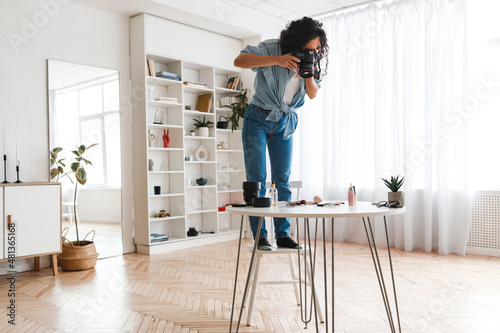 Photographer Woman Taking Photo Of Cosmetics Products On Desktop Indoor