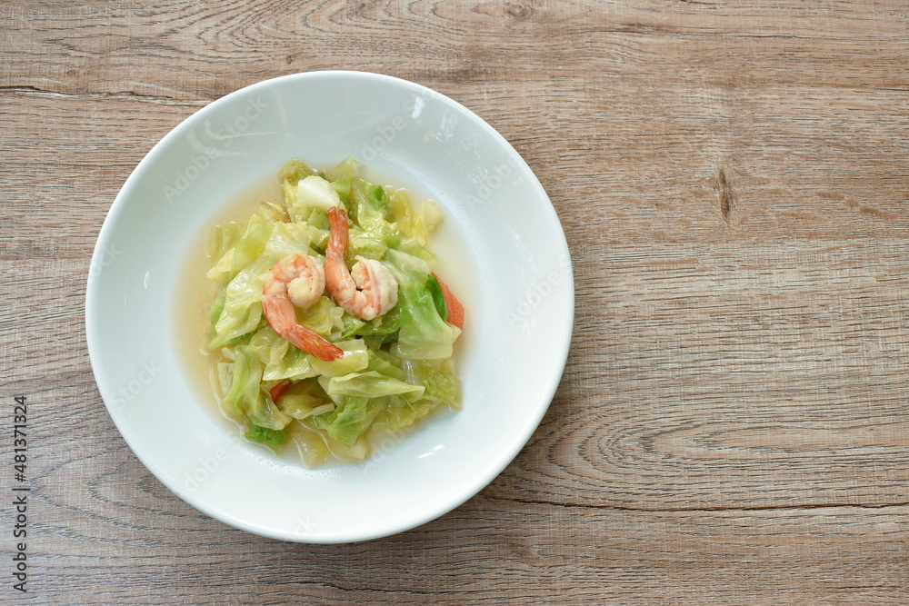 fried slice cabbage and carrot with shrimp in soy sauce on plate