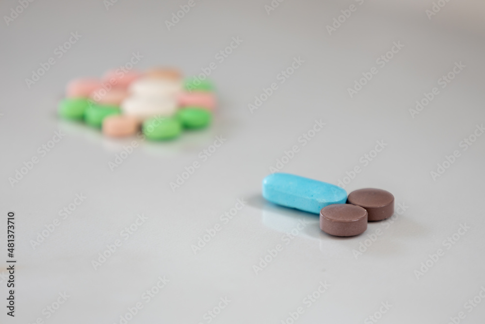 Colored pills simulating male genitalia reaching an egg. Selective focus. Colored pills simulating male genitalia reaching an egg. Selective focus.