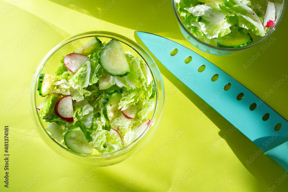custom made wallpaper toronto digitalSalad with radish, cucumber and Chinese cabbage leaves. Fresh vegetable salad in a glass bowl on a green background. Slicing knife.