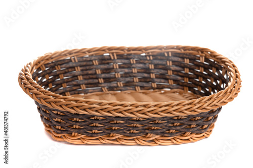 brown wicker fruit basket on white isolated background