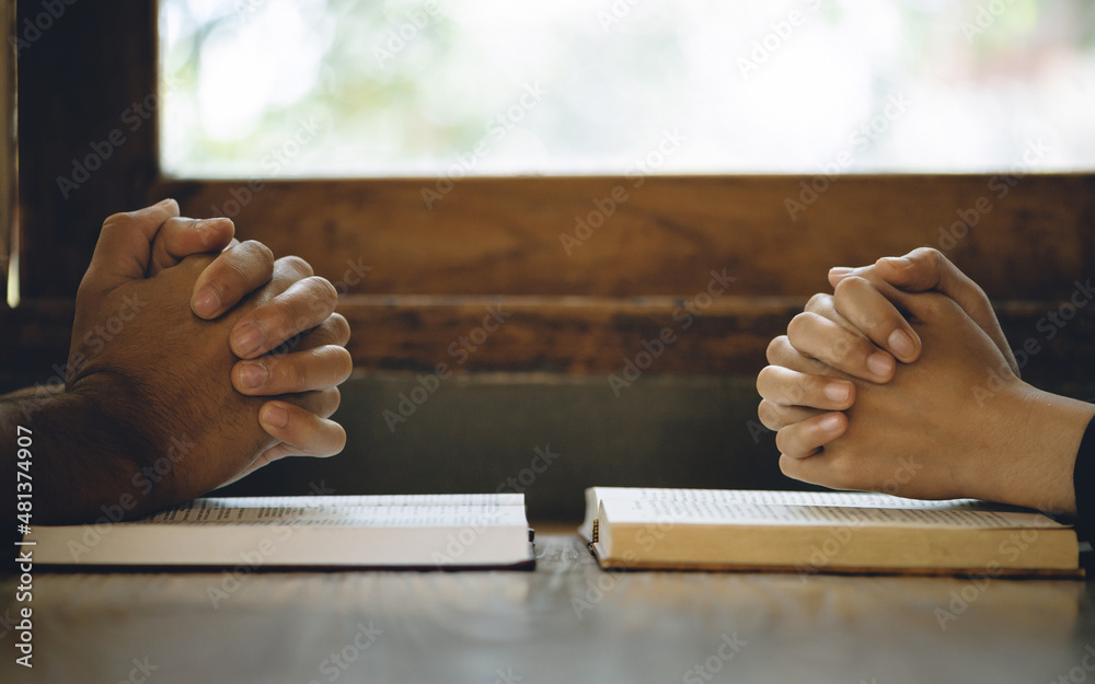 Obraz premium Christian life crisis prayer to god. Women Pray for god blessing to wishing have a better life. Hands praying to god with the bible. believe in goodness. Holding hands in prayer on a wooden table.