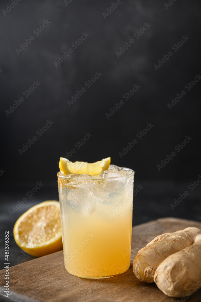 Homemade Kombucha with honey, lemon and ginger on black background. Heathy organic probiotic drink. Vertical format. Close up. Homemade Kombucha with honey, lemon and ginger on black background. Heathy organic probiotic drink. Vertical format. Close up.