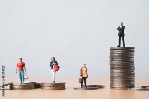 Businessman standing on highest coins stacking and shopper standing on lower coins pile for investment can make more money and opportunity to richer concept. photo