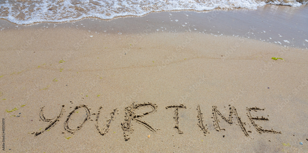 Fototapeta premium Handwriting word your time written in the sand