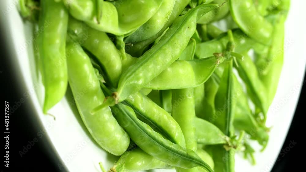 Fresh green peas pods rotation close up. Loop motion. Vertical orientation Fresh green peas pods rotation close up. Loop motion. Vertical orientation