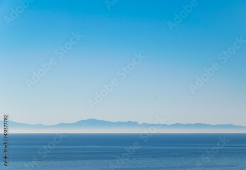 a landscape background wallpaper image looking out over the Mediterranean Sea at the mountainous coast of northern Africa 