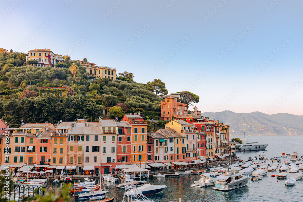 Liguria, Italy, Europe.  View from above over beautiful Portofino with colorful houses and villas,  in little bay harbor.