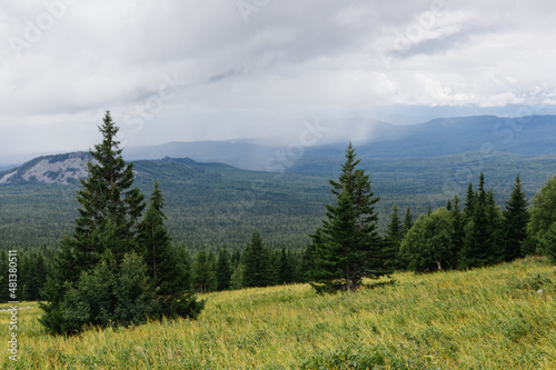 View on a rain clouds over mountain forest valley in Russia