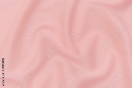 Close-up texture of natural red or pink fabric or cloth in same color. Fabric texture of natural cotton, silk or wool, or linen textile material. Red canvas background. photo