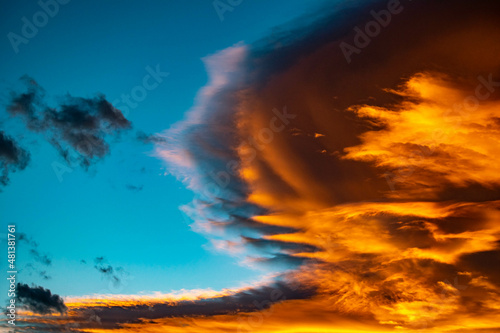 a landscape image of golden orange clouds with blue skies during a sunset over the city of Marbella in the Costa Del Sol background wallpaper 